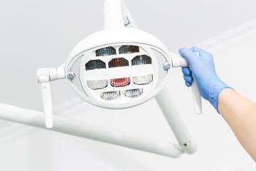  female dentist hand adjusting electric light at Dentistry clinic- Stock Photo or Stock Video of rcfotostock | RC Photo Stock
