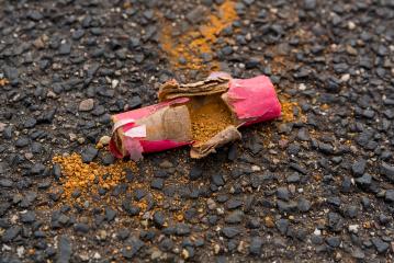 Scattered piece of a firecracker are spread on the ground.- Stock Photo or Stock Video of rcfotostock | RC-Photo-Stock