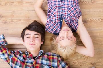 A boy and a girl wearing plaid shirts lying on a wooden floor with their eyes closed, smiling peacefully, enjoying a relaxed and happy moment together : Stock Photo or Stock Video Download rcfotostock photos, images and assets rcfotostock | RC Photo Stock.: