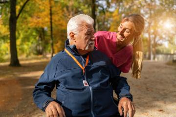 A caregiver in pink assists a joyful elderly man in a wheelchair, who wears a blue jacket with an SOS button. : Stock Photo or Stock Video Download rcfotostock photos, images and assets rcfotostock | RC Photo Stock.: