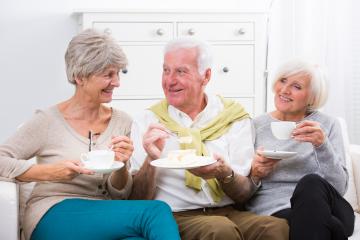 A cheerful group of senior friends enjoying coffee and cake together in a bright and cozy living room, showcasing warmth, friendship, and a relaxed social gathering : Stock Photo or Stock Video Download rcfotostock photos, images and assets rcfotostock | RC Photo Stock.: