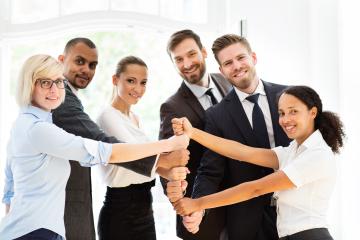 A diverse group of business professionals smiling and collaborating, symbolizing teamwork, unity, and success in a bright office setting : Stock Photo or Stock Video Download rcfotostock photos, images and assets rcfotostock | RC Photo Stock.: