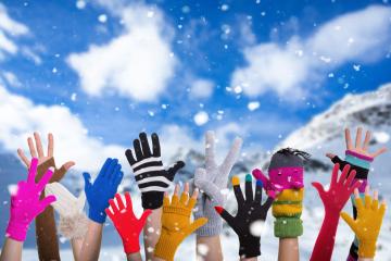 A group of colorful gloved hands raised into the snowy winter air, set against a bright blue sky and snowy mountain landscape, celebrating fun and joy in a festive outdoor winter scene.
 : Stock Photo or Stock Video Download rcfotostock photos, images and assets rcfotostock | RC Photo Stock.: