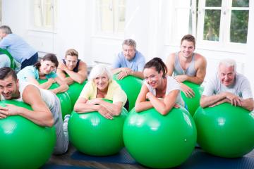 A group of diverse people of different ages enjoying an exercise class with green stability balls in a bright fitness studio, promoting health, teamwork, and an active lifestyle : Stock Photo or Stock Video Download rcfotostock photos, images and assets rcfotostock | RC Photo Stock.: