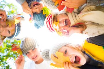 A group of joyful children wearing cozy winter hats and scarves, holding colorful autumn leaves, laughing and playing outdoors, surrounded by vibrant fall foliage and natural light : Stock Photo or Stock Video Download rcfotostock photos, images and assets rcfotostock | RC Photo Stock.: