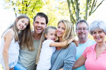 A happy multigenerational family smiling outdoors in a sunny park, including children, parents, and grandparents, enjoying quality time together
 : Stock Photo or Stock Video Download rcfotostock photos, images and assets rcfotostock | RC Photo Stock.: