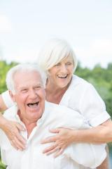 A happy senior couple laughing and enjoying an outdoor moment together, with a bright and joyful atmosphere and a green nature background on a sunny day. : Stock Photo or Stock Video Download rcfotostock photos, images and assets rcfotostock | RC Photo Stock.: