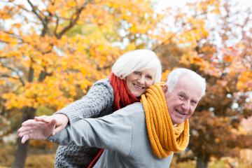 A joyful elderly couple embracing in a park surrounded by vibrant autumn foliage, wearing colorful scarves and smiling, symbolizing love, happiness, and enjoying life together in the golden years : Stock Photo or Stock Video Download rcfotostock photos, images and assets rcfotostock | RC Photo Stock.: