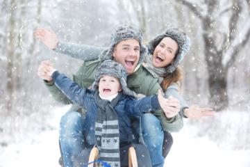 A joyful family sledding in a snowy winter forest, wearing warm hats and jackets, laughing and celebrating together, surrounded by falling snowflakes in a magical outdoor setting
 : Stock Photo or Stock Video Download rcfotostock photos, images and assets rcfotostock | RC Photo Stock.: