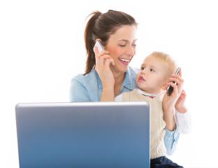 A mother multitasks while on a phone call, holding her young child who is also playing with a phone, both sitting in front of a laptop against a bright white background. : Stock Photo or Stock Video Download rcfotostock photos, images and assets rcfotostock | RC Photo Stock.: