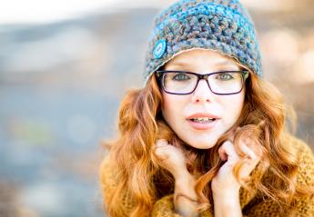 A red-haired woman with glasses and a knitted hat, looking at the camera with a curious and warm expression, wearing a cozy sweater, outdoors in a soft autumn light : Stock Photo or Stock Video Download rcfotostock photos, images and assets rcfotostock | RC Photo Stock.: