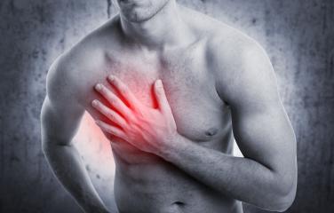 A shirtless man clutching his chest with a highlighted red area symbolizing chest pain, heart health, or a medical issue, set against a grayscale background for emphasis. : Stock Photo or Stock Video Download rcfotostock photos, images and assets rcfotostock | RC Photo Stock.: