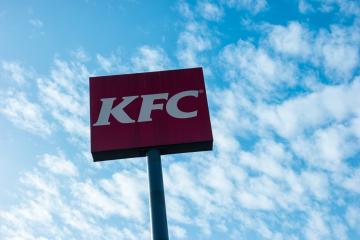 AACHEN, GERMANY FEBRUARY, 2017: Kentucky Fried Chicken Restaurant Logo with cloudy sky. It is a fast food restaurant chain headquartered in United States specialized in chicken products.- Stock Photo or Stock Video of rcfotostock | RC-Photo-Stock