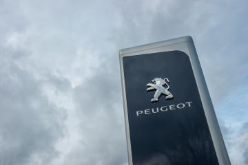 AACHEN, GERMANY FEBRUARY, 2017: Peugeot dealership sign against cloudy sky. Peugeot is a French automobile manufacturer and part of Groupe PSA.- Stock Photo or Stock Video of rcfotostock | RC Photo Stock