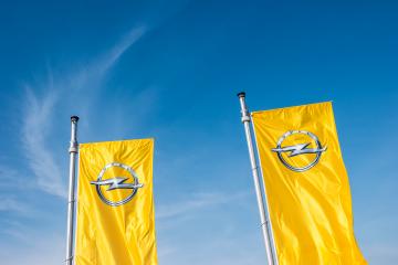 AACHEN, GERMANY MARCH, 2017: Opel flags against blue sky at the Opel Store. Opel AG is a German automobile manufacturer.- Stock Photo or Stock Video of rcfotostock | RC Photo Stock