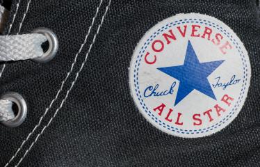 AACHEN, GERMANY OCTOBER, 2017: Converse All star logo printed on the side of the shoe. Founded in 1908 is an American lifestyle company with a production output of shoes and lifestyle fashion.- Stock Photo or Stock Video of rcfotostock | RC-Photo-Stock