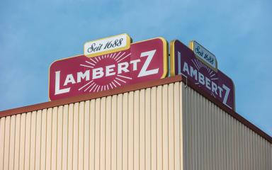 AACHEN, GERMANY OCTOBER, 2017: Lambertz Logo on a factory building. The Lambertz Group is a Aachener Printen- and chocolate factory founded by Henry Lambertz 1688 and a manufacturer Christmas cookies. : Stock Photo or Stock Video Download rcfotostock photos, images and assets rcfotostock | RC Photo Stock.: