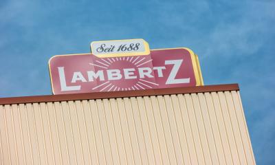 AACHEN, GERMANY OCTOBER, 2017: Lambertz Logo on a factory building. The Lambertz Group is a Aachener Printen- and chocolate factory founded by Henry Lambertz 1688 and a manufacturer Christmas cookies.- Stock Photo or Stock Video of rcfotostock | RC-Photo-Stock