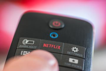 AACHEN, GERMANY OCTOBER, 2017:Man holds a remote control with a Netflix button. Netflix Inc. is an American company founded specializes in and provides streaming media and video on demand online.- Stock Photo or Stock Video of rcfotostock | RC-Photo-Stock