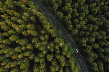 Aerial view of car driving through the forest on country road.- Stock Photo or Stock Video of rcfotostock | RC Photo Stock