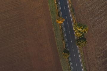 Aerial view of traffic on two lane road through countryside and cultivated fields- Stock Photo or Stock Video of rcfotostock | RC Photo Stock