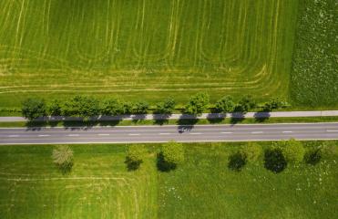 Aerial view of two lane road through countryside and cultivated fields. Drone shot and copy space for text- Stock Photo or Stock Video of rcfotostock | RC Photo Stock