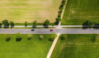 Aerial view of two lane road through countryside and cultivated fields with cars. Drone shot and copy space for text- Stock Photo or Stock Video of rcfotostock | RC-Photo-Stock
