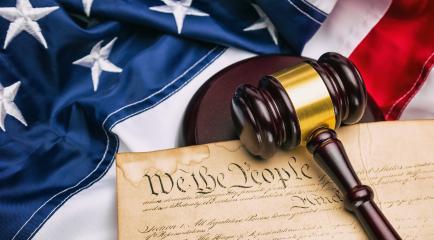 American flag with US constitution and a judge's gavel symbolizing the American justice system or the Judicial Branch of government- Stock Photo or Stock Video of rcfotostock | RC Photo Stock