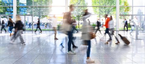 Anonymous crowd of business people go by gear on a trade fair- Stock Photo or Stock Video of rcfotostock | RC Photo Stock