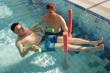 Aquatic rehab exercise with patient using pool noodles for suppo- Stock Photo or Stock Video of rcfotostock | RC Photo Stock