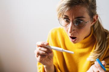 attractive woman holding pregnancy test at home looking at positive result in shock and stress having surprise in girl unwanted maternity concept image : Stock Photo or Stock Video Download rcfotostock photos, images and assets rcfotostock | RC Photo Stock.: