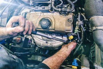 Auto mechanic working on car engine in mechanics garage. Repair service. authentic close-up shot- Stock Photo or Stock Video of rcfotostock | RC Photo Stock