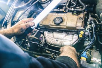 Auto mechanic working on car engine in mechanics garage with a lamp. Repair service. authentic close-up shot  : Stock Photo or Stock Video Download rcfotostock photos, images and assets rcfotostock | RC Photo Stock.: