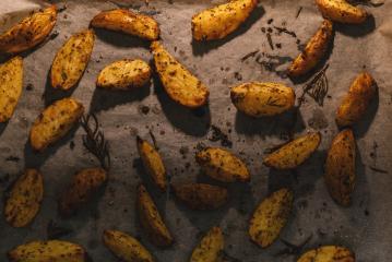 Baked potato wedges with rosemary and oil -  homemade organic vegetable vegan vegetarian potato wedges snack food meal.- Stock Photo or Stock Video of rcfotostock | RC Photo Stock
