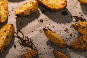 Baked potato wedges with rosemary and oil in a oven -  homemade organic vegetable vegan vegetarian potato wedges snack food meal.- Stock Photo or Stock Video of rcfotostock | RC Photo Stock