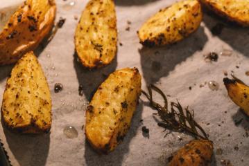 Baked potato wedges with rosemary on baking paper -  homemade organic vegetable vegan vegetarian potato wedges snack food meal.- Stock Photo or Stock Video of rcfotostock | RC Photo Stock
