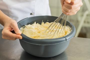 baker woman holding bowl with dough and whisk to beat stirring butter for a cake  : Stock Photo or Stock Video Download rcfotostock photos, images and assets rcfotostock | RC Photo Stock.: