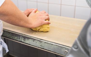 baker's hands kneading cookie dough on a work surface in a bakery, preparing it for baking. The textured surface and dough particles add a rustic touch to the process : Stock Photo or Stock Video Download rcfotostock photos, images and assets rcfotostock | RC Photo Stock.: