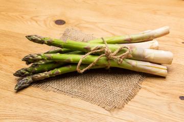 banches of fresh green asparagus on wooden background, top view- Stock Photo or Stock Video of rcfotostock | RC Photo Stock