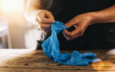 bartender or employee wearing a medical Latex gloves at work to prevent corona COVID-19 and SARS infection- Stock Photo or Stock Video of rcfotostock | RC Photo Stock