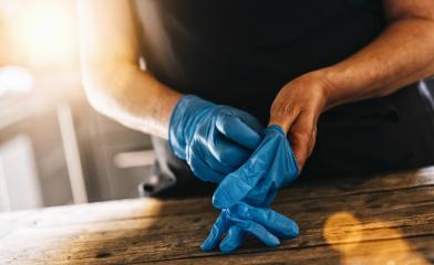 bartender or employee wearing a medical Latex gloves at work to prevent Coronavirus corona virus covid 19 infection.- Stock Photo or Stock Video of rcfotostock | RC Photo Stock