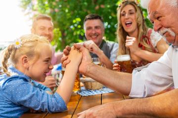 Bavarian family practicing the high art of arm wrestling in a beer garden- Stock Photo or Stock Video of rcfotostock | RC Photo Stock