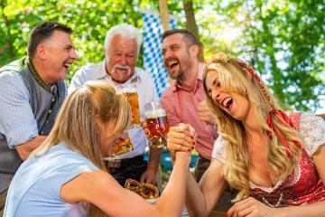 Bavarian friends practicing the high art of arm wrestling in a beer garden- Stock Photo or Stock Video of rcfotostock | RC Photo Stock