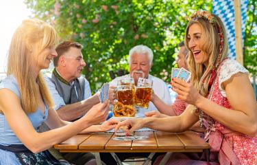 Bavarian people in traditional costume playing cards in beer garden or oktoberfest : Stock Photo or Stock Video Download rcfotostock photos, images and assets rcfotostock | RC Photo Stock.: