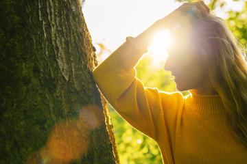 beautiful woman with long blond hair leans against a tree on a sunny day in the Nature- Stock Photo or Stock Video of rcfotostock | RC Photo Stock