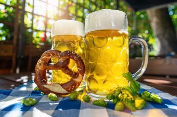 Beer mugs with fresh pretzel or brezen and hops at Oktoberfest, Munich, Germany- Stock Photo or Stock Video of rcfotostock | RC Photo Stock