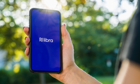 BERLIN, GERMANY AUGUST 2019: Woman hand holding iphone Xs with logo of Libra in the park. Libra Facebook cryptocurrency and bitcoin cryptocurrency smartphone share, Libra coins concept.- Stock Photo or Stock Video of rcfotostock | RC Photo Stock