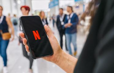 BERLIN, GERMANY AUGUST 2019: Woman hand holding iphone Xs with logo of Netflix app. Young woman is browsing the movie video library what to watch.- Stock Photo or Stock Video of rcfotostock | RC Photo Stock