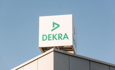 BERLIN, GERMANY JULY 2019: Dekra logo on a building. Dekra is a vehicle inspection company founded in Berlin, Germany in 1925. Dekra is the third largest inspection company in the world- Stock Photo or Stock Video of rcfotostock | RC Photo Stock