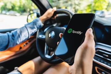 BERLIN, GERMANY JULY 2019: Woman holding a iPhone Xs opening spotify app in a car, Spotify is a music service that offers legal streaming music.- Stock Photo or Stock Video of rcfotostock | RC-Photo-Stock